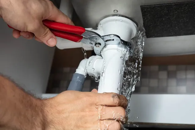 Emergency plumber responding to drain backup with professional equipment