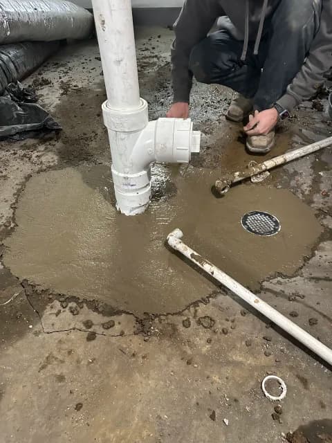 Finished floor drain repair with new cleanout and fresh concrete patch