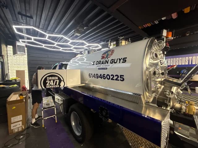 Professional pump service technician with specialized pumping equipment for septic tanks and grease traps